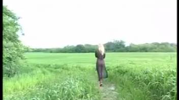 Woman in sheer black dress defecating and urinating