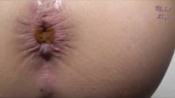 Attractive woman's butt with liquid defecation